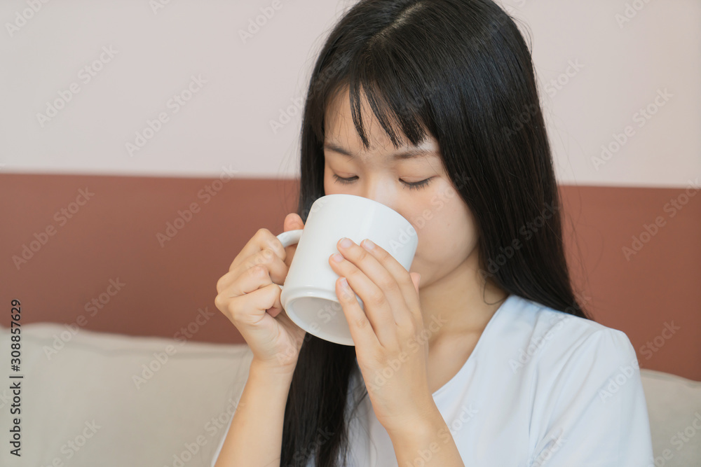 asian young woman drink coffee on sofa asian young woman drink coffee on sofa