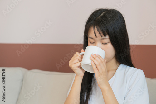 asian young woman drink coffee on sofa