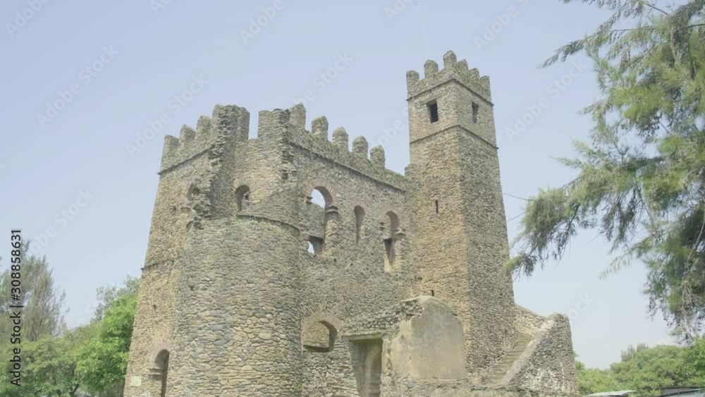 Camera forward wide angle full view of Fasilides Archive ruins tilt down to reveal doorway view of courtyard and stairs in the Fasil Ghebbi royal enclosure in Gondar, Ethiopia Camera forward wide angle full view of Fasilides Archive ruins tilt down to reveal doorway view of courtyard and stairs in the Fasil Ghebbi royal enclosure in Gondar, Ethiopia