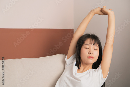 young woman stretch herself on sofa