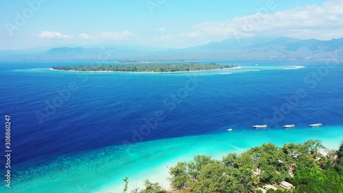 Wallpaper Mural Island In Indonesia - Tropical Paradise Of Green Trees And White Sand Surrounded By Deep Blue Sea Water With Boats Lined Near The Shore - Wide Shot Torontodigital.ca