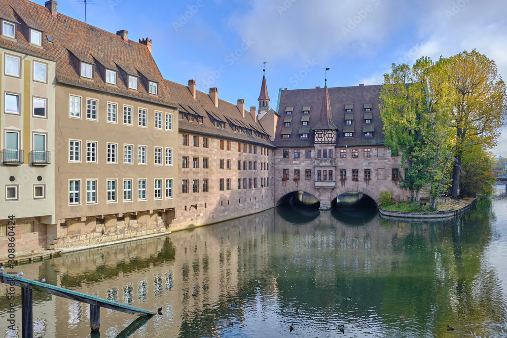 Scenic view of Pegnitz river between old houses in Nuremberg - second-largest city of federal state of Bavaria in Germany. Beautiful summer sunny look of small river in ancient city in Europe