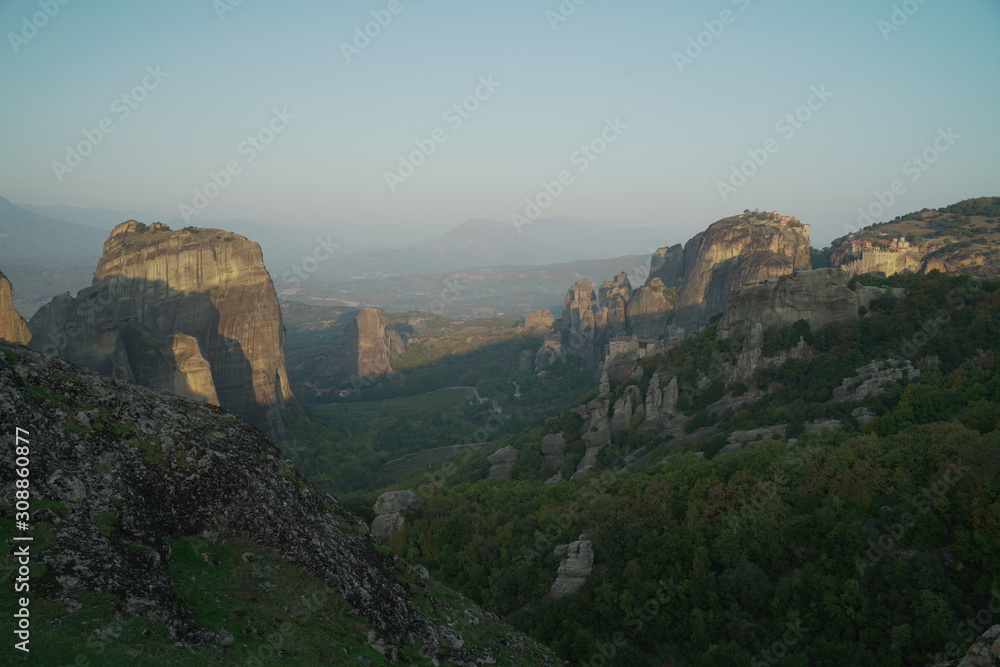 The Holy Monastery of Roussanou and Monastery of Agios Nikolaos Anapafsas situated on the steep cliffs, mountains panorama, Kalampaka, Trikala, Thessaly, Greece