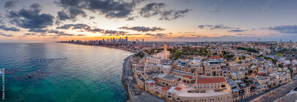 Aerial view of Tel Aviv Yafo along the Mediterranean sea at predawn with colorful sky over the city in Israel