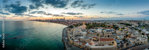 Aerial view of Tel Aviv Yafo along the Mediterranean sea at predawn with colorful sky over the city in Israel
