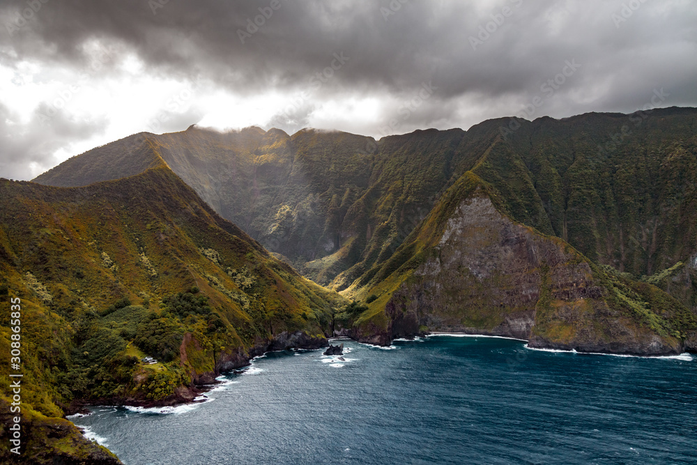 Beautiful nature of Hawaii paradise: mountains, ocean and clods shot from helicopter (aerial pic) at summer sunset time