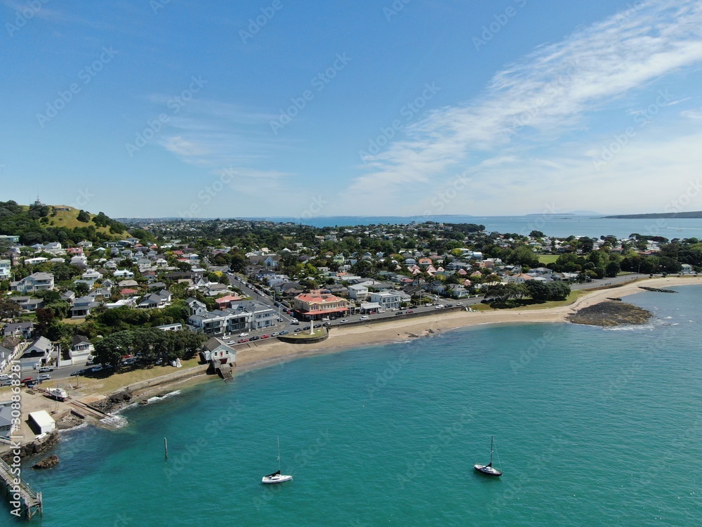 Devonport, Auckland / New Zealand - December 11, 2019: The Victorian Style Seaside Village of Devonport, with the skyline of Auckland’s landmarks and CBD in the background