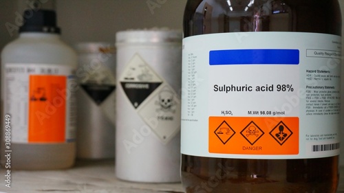 Bottle of Sulfuric Acid, H2SO4 with Properties information and its chemical hazard warning symbols. Corrosive hazard symbol, Inhalation hazard symbol and Toxic symbol