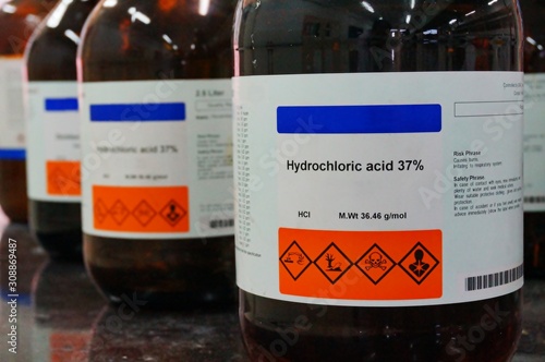 Bottle of Hydrochloric Acid, HCL with Properties information and its chemical hazard warning symbols. Corrosive, Inhalation,Toxic warning, Hazardous to the Environment.