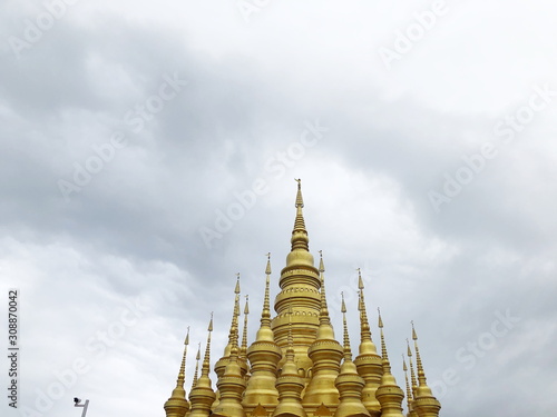 Golden pagoda in Buddhist temple in Xishuangbanna, Sipsongpanna, or Sibsongbanna in the south of Yunnan province, People's Republic of China. photo