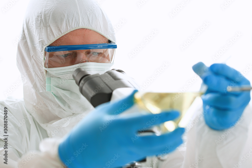 Male chemist in blue protective gloves look Male chemist in blue protective gloves look