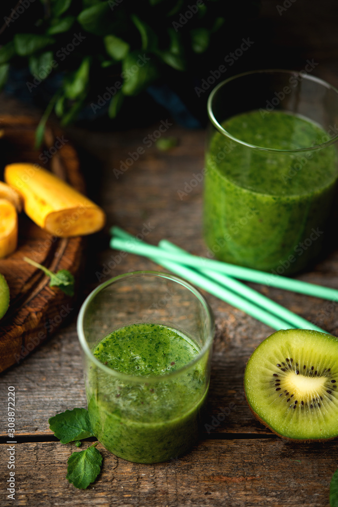 Vegetarian green smoothie with banana, kiwi, spinach and mint leaves. The concept of clean eating. Vegetarian green smoothie with banana, kiwi, spinach and mint leaves. The concept of clean eating.
