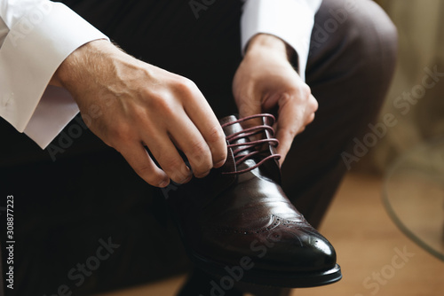 Fototapeta Naklejka Na Ścianę i Meble -  Men's shoes in hands close up