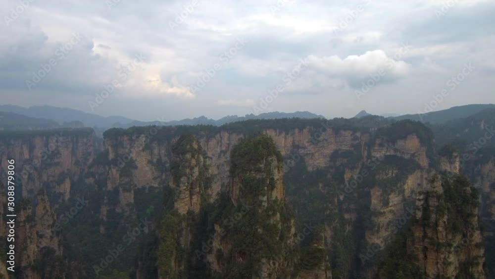 Drone footage of tall rock pillars (forest) and vegetation on them in ...
