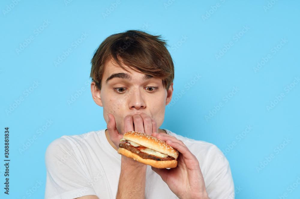 man eating hamburger man eating hamburger