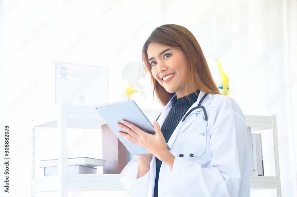 Female doctor checking the treatment results of the patients in a tablet . Female doctor checking the treatment results of the patients in a tablet .