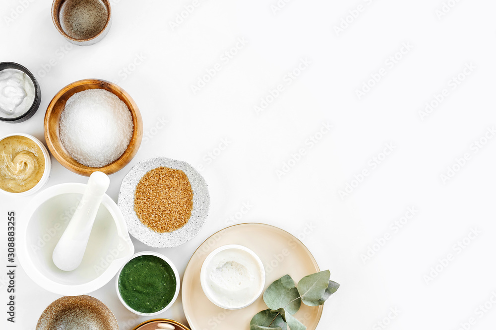Beauty treatment ingredients for making homemade skin care cosmetic mask. Various bowl with clay, cream, essential oil and natural ingredients  on white table background. Organic spa cosmetic products - obrazy, fototapety, plakaty 