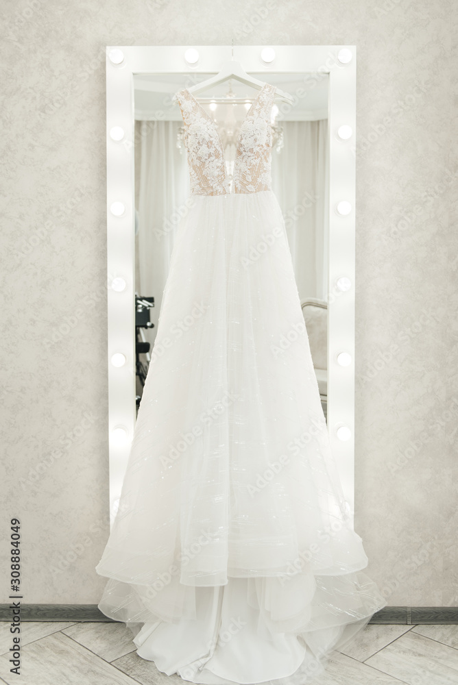 wedding dress hanging on the mirror, bride's morning wedding dress hanging on the mirror, bride's morning