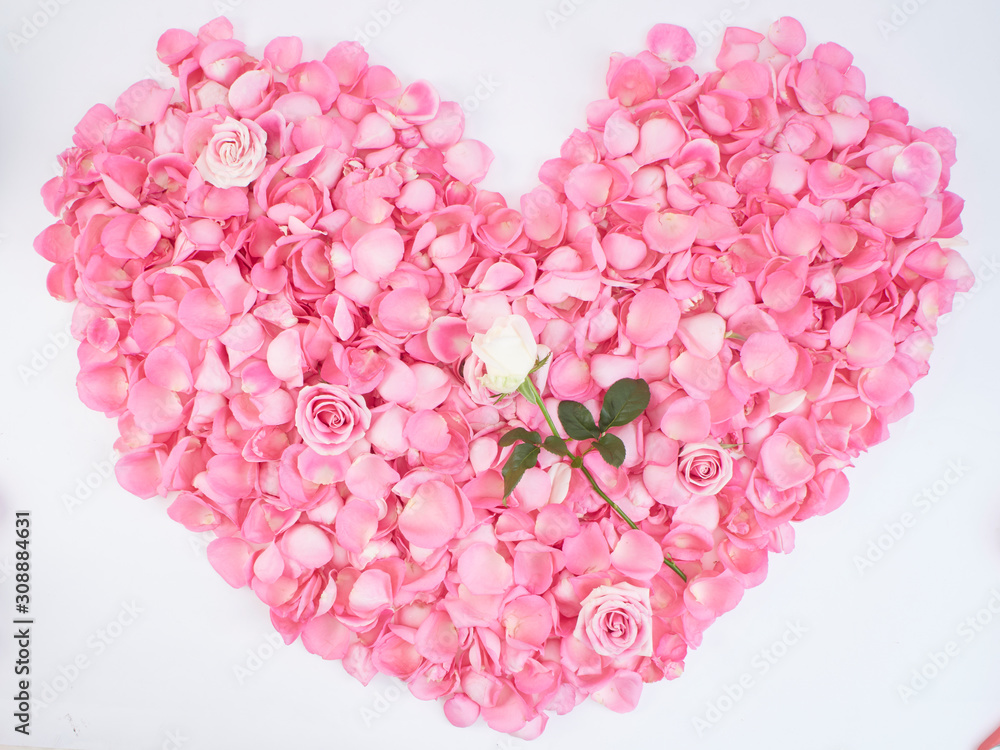 Heart symbol made of pink rose petals.