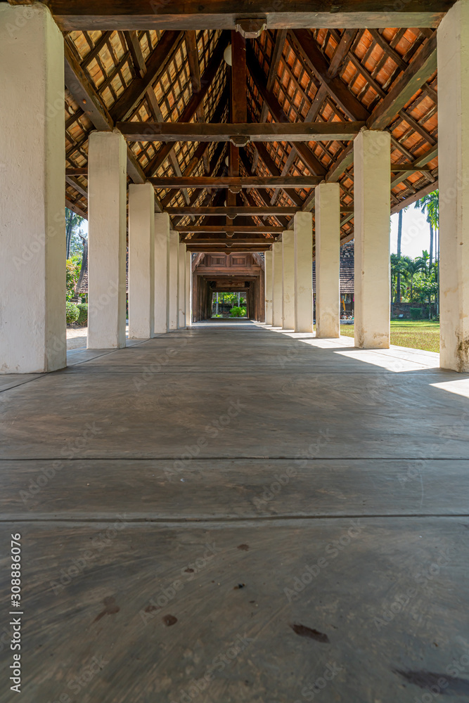 Ancient roof structure of thailand traditional architecture with concrete walkway in temple