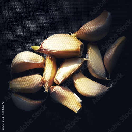 Garlic on black cutting board still life