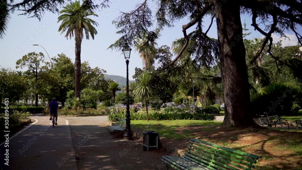 Slowmotion of cyclist on bicycle path in Italian park Slowmotion of cyclist on bicycle path in Italian park