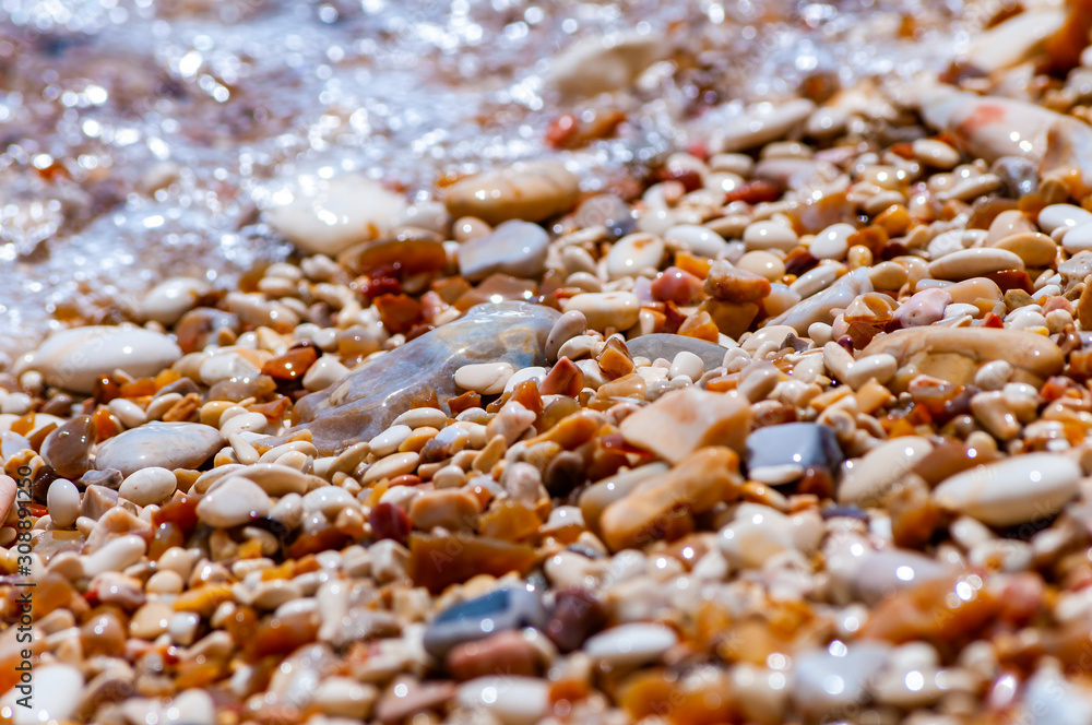 Coastal pebbles washed by Adriatic Sea water waves on Baia delle Zagare beach in Gargano National Park, Italy Coastal pebbles washed by Adriatic Sea water waves on Baia delle Zagare beach in Gargano National Park, Italy