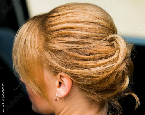 Women's festive hairstyle, hair pulled up and pinned back