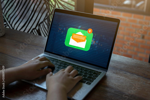 Person using a laptop computer with email communication connection message online and chat on social media with global letters concept. Laptop mockup with clipping path on screen.