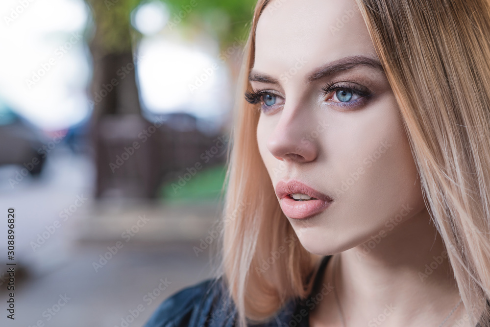 Beautiful blonde girl, model looks in the distance, close-up, outdoors. Beautiful blonde girl, model looks in the distance, close-up, outdoors.
