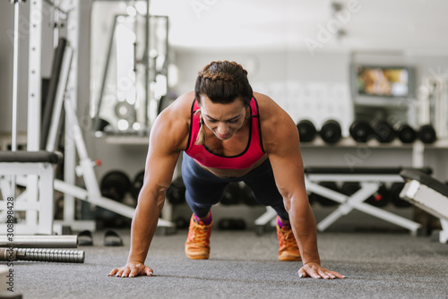 bodybuilder push ups on the gym floor