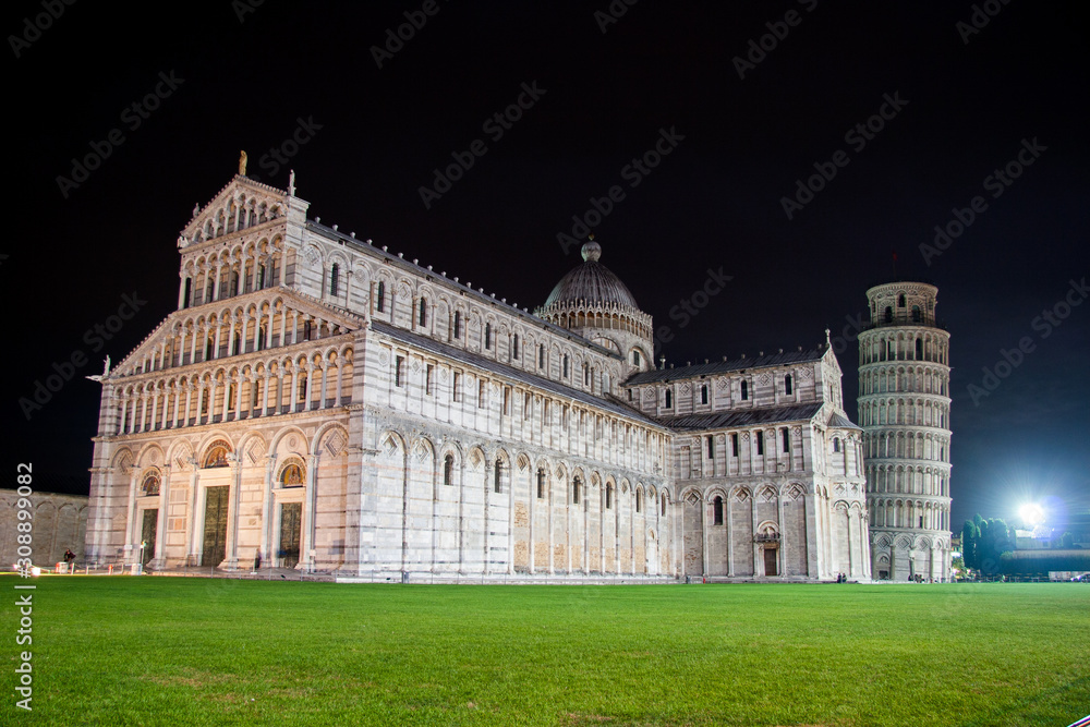 Cathedral and leaning tower of Pisa against the night sky on a warm autumn day