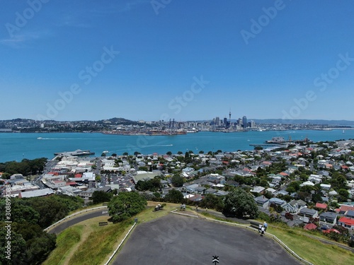 Devonport, Auckland / New Zealand - December 11, 2019: The Victorian Style Seaside Village of Devonport, with the skyline of Auckland’s landmarks and CBD in the background