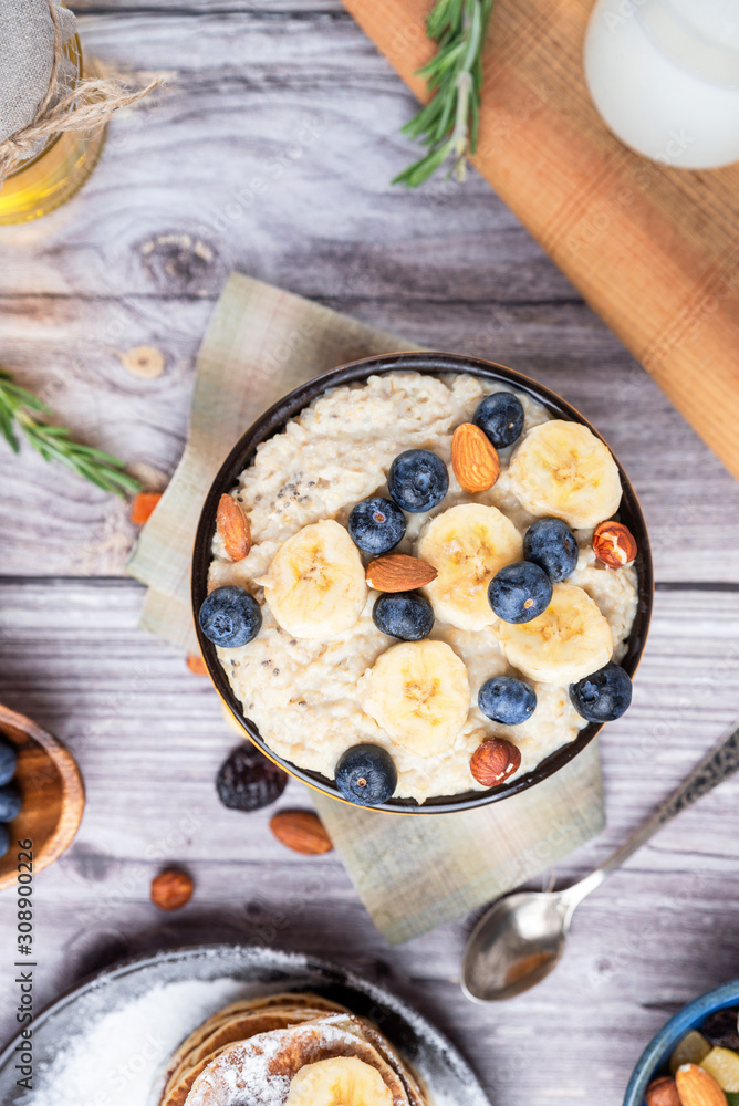 rustic delicious Breakfast oatmeal with nuts and bananas and pancakes rustic delicious Breakfast oatmeal with nuts and bananas and pancakes