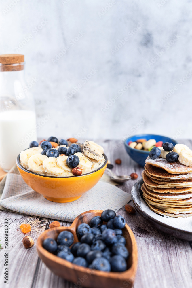 rustic Breakfast pancakes on a plate with blueberries and oatmeal rustic Breakfast pancakes on a plate with blueberries and oatmeal
