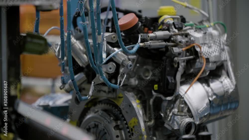Car engine assembly on the production line inside an automobile manufacturing plant Car engine assembly on the production line inside an automobile manufacturing plant
