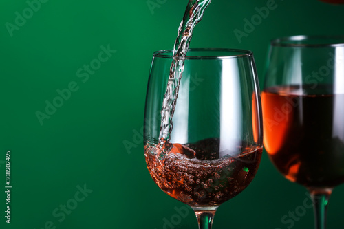 Εκτύπωση καμβά Pouring of tasty wine into against color background