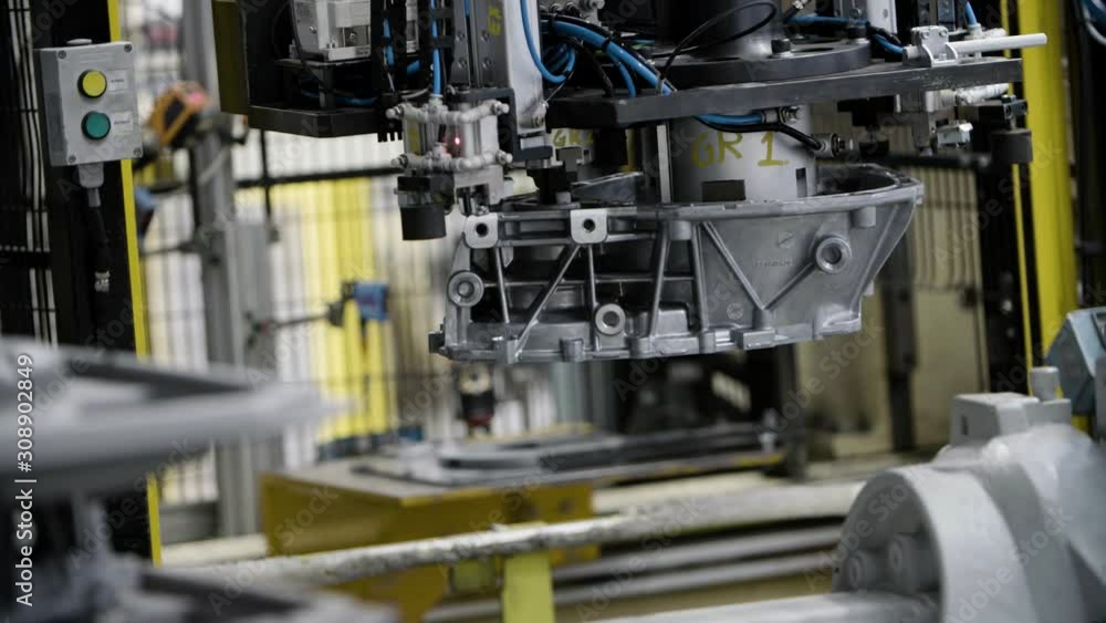 Car engine assembly on the production line inside an automobile manufacturing plant Car engine assembly on the production line inside an automobile manufacturing plant