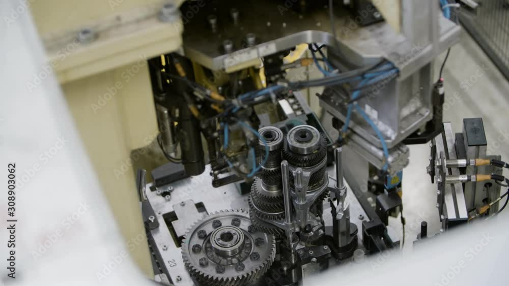 Car engine assembly on the production line inside an automobile manufacturing plant Car engine assembly on the production line inside an automobile manufacturing plant