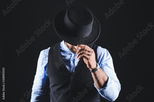 Stylish young man on dark b...