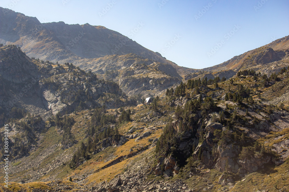 Fototapeta premium In the distance, Refuge of Campana de Cloutou in the Pyrenees mountains
