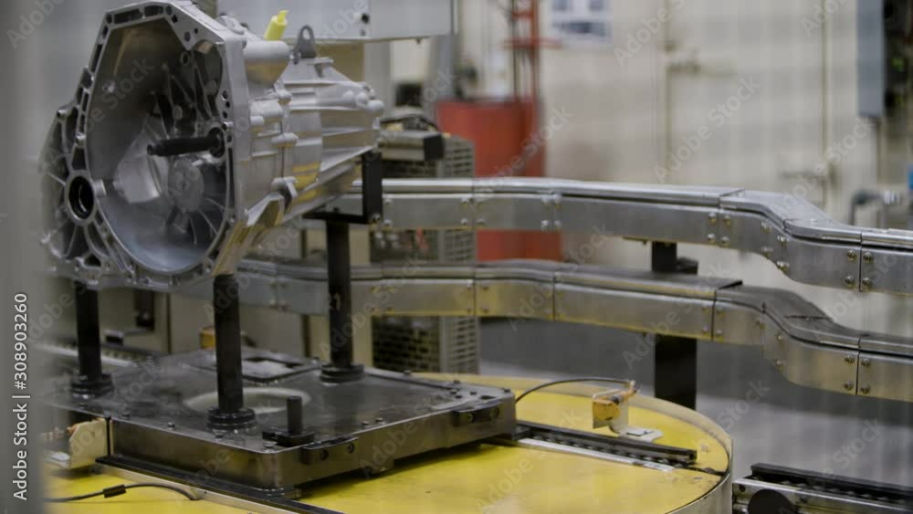 Car engine assembly on the production line inside an automobile manufacturing plant Car engine assembly on the production line inside an automobile manufacturing plant