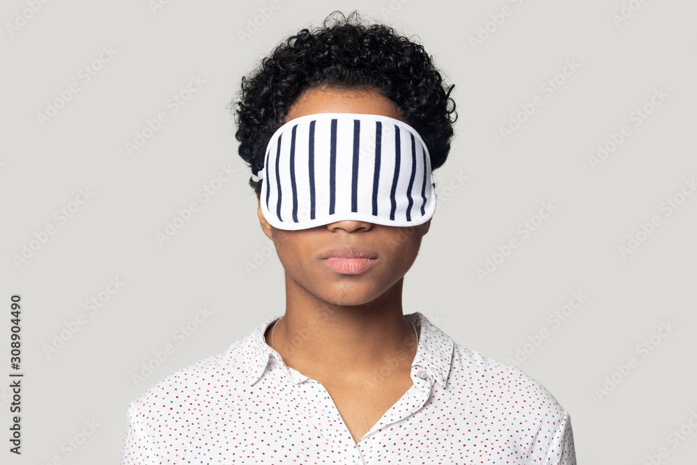 Young african american woman standing with sleeping mask on eyes. Young african american woman standing with sleeping mask on eyes.