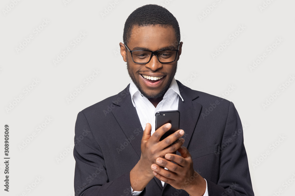 Head shot cheerful millennial african american guy holding smartphone. Head shot cheerful millennial african american guy holding smartphone.