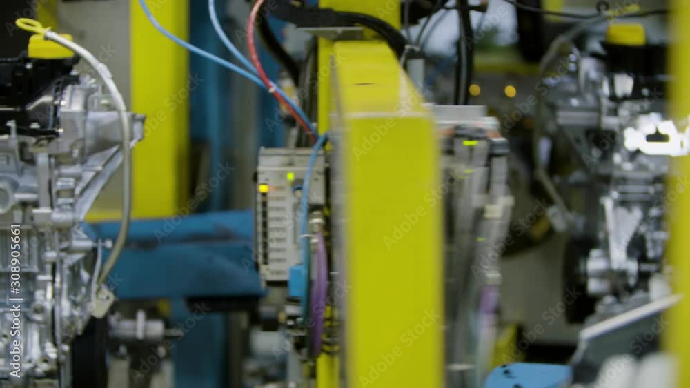 Car engine assembly on the production line inside an automobile manufacturing plant Car engine assembly on the production line inside an automobile manufacturing plant