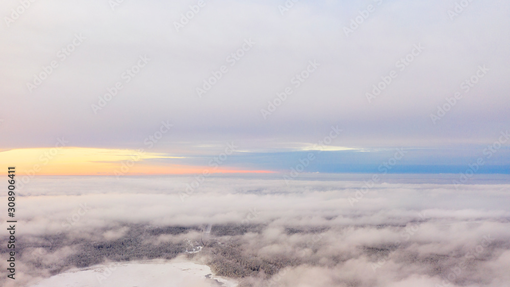 Obraz premium Aerial view White clouds in blue sky. Top view. View from drone. Aerial bird's eye view. Aerial top view cloudscape. Texture of clouds. View from above. Sunrise or sunset over clouds