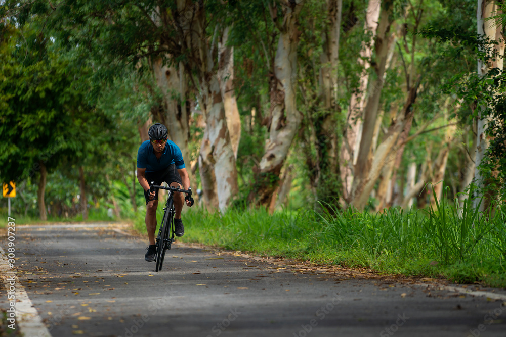 man cycling bicycle for exercise on the road in morning man cycling bicycle for exercise on the road in morning