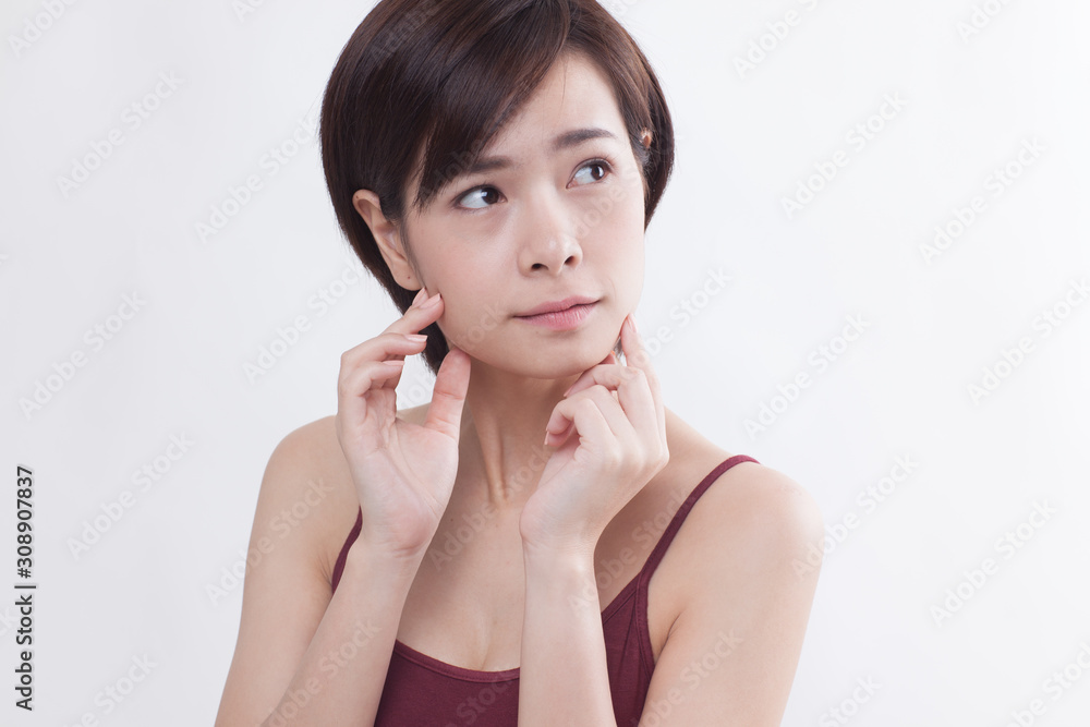 Young beautiful Asian female model on the white background Young beautiful Asian female model on the white background