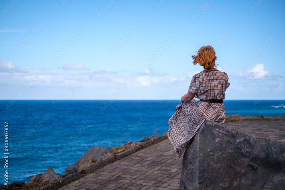 woman  sitting on top of mountain