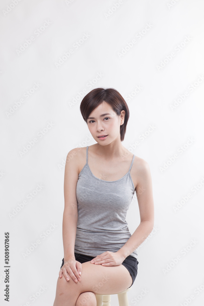 Young beautiful Asian female model on the white background Young beautiful Asian female model on the white background